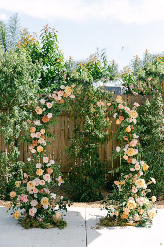 Wedding ceremony asymmetrical arch with garden florals